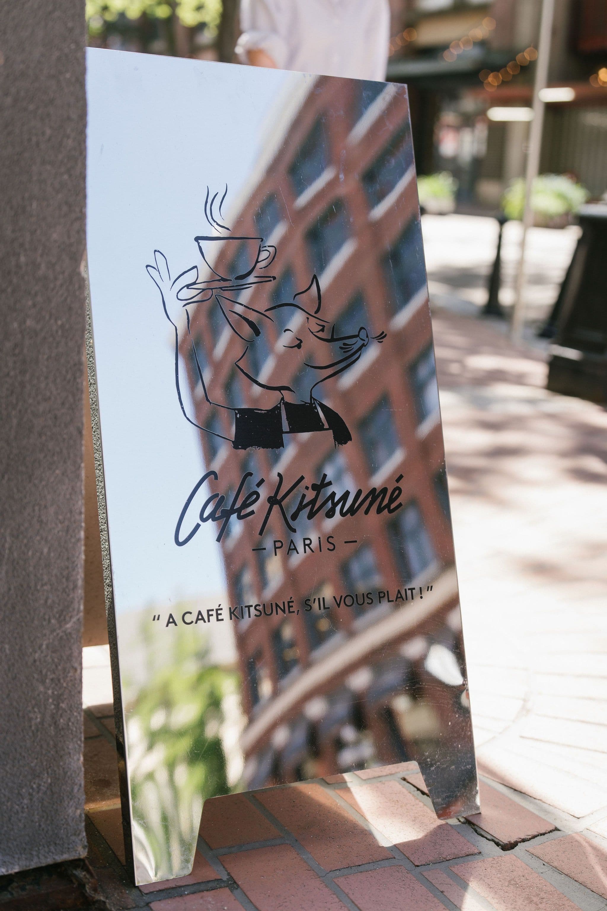Reflective Café Kitsuné sign outside the Vancouver café.
