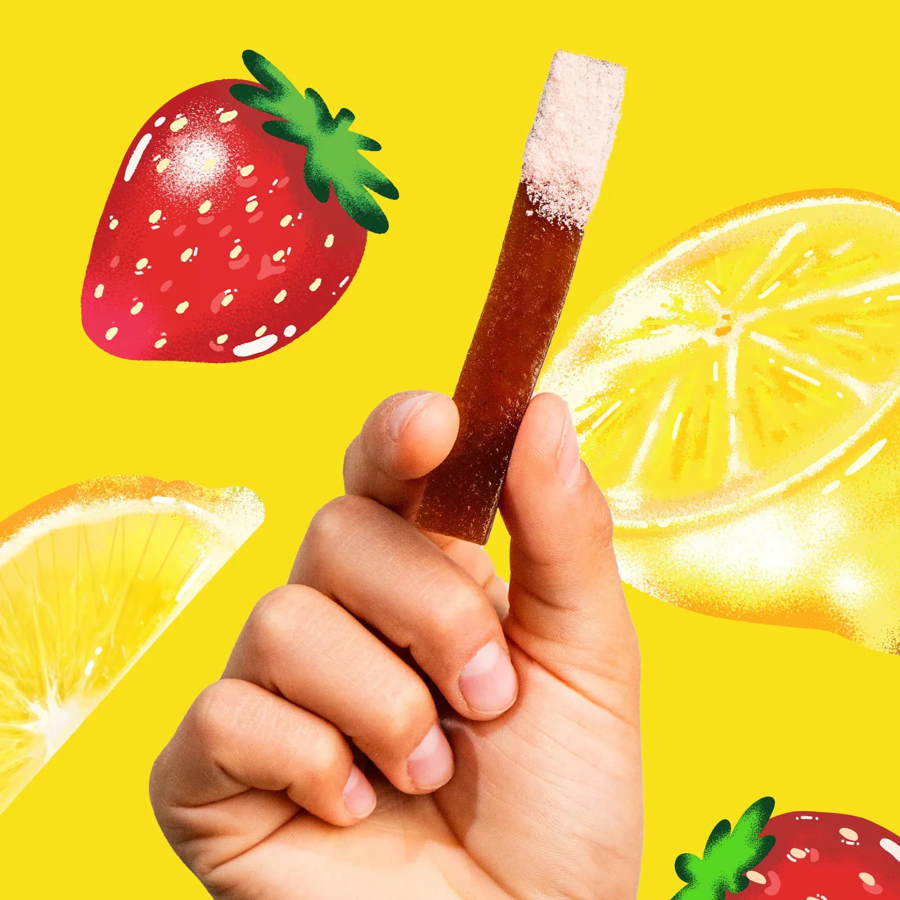 A hand holding a red freezie against a yellow background with strawberries and lemon slices.